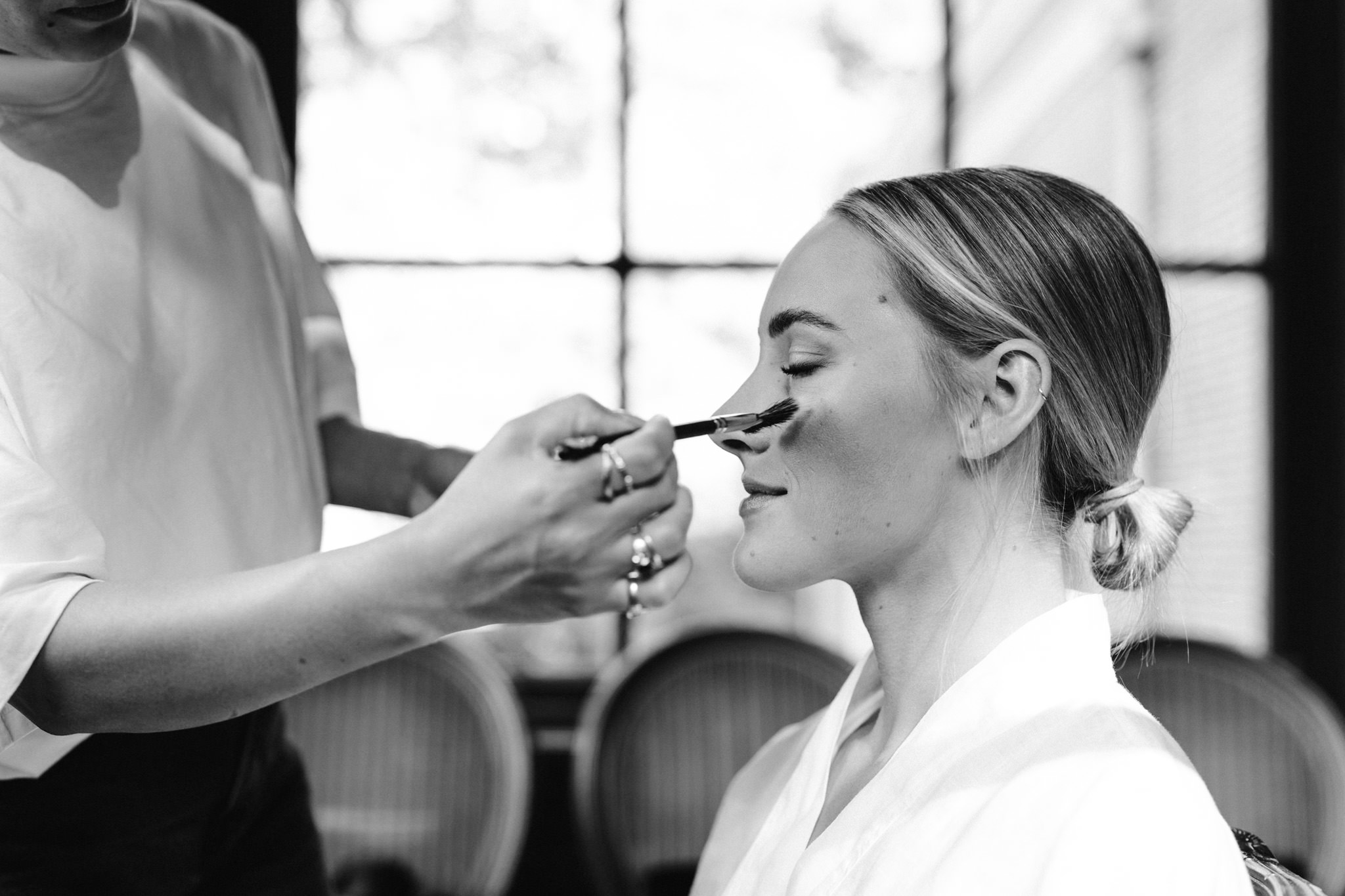 Make-up artist styling bride before the wedding at Huize Frankendael